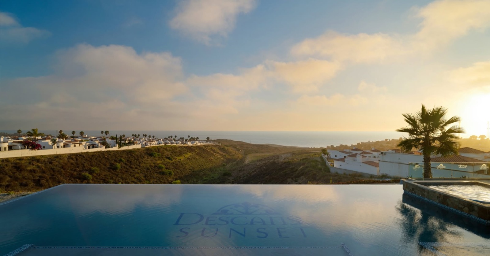Infinity pool at sunset flowing into the Pacific Ocean at Loma Serena