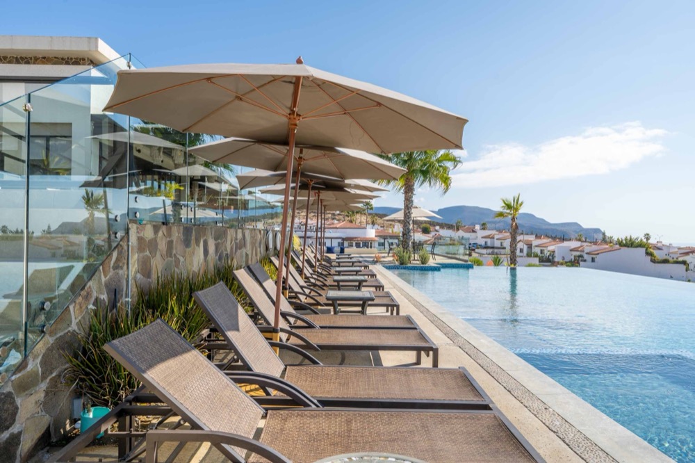 Infinity pool with loungers at the residents' club