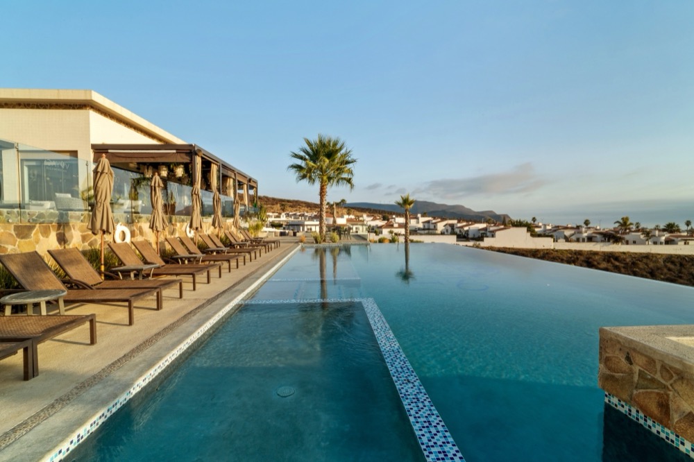 Golden sunrise light over the residents' club infinity pool