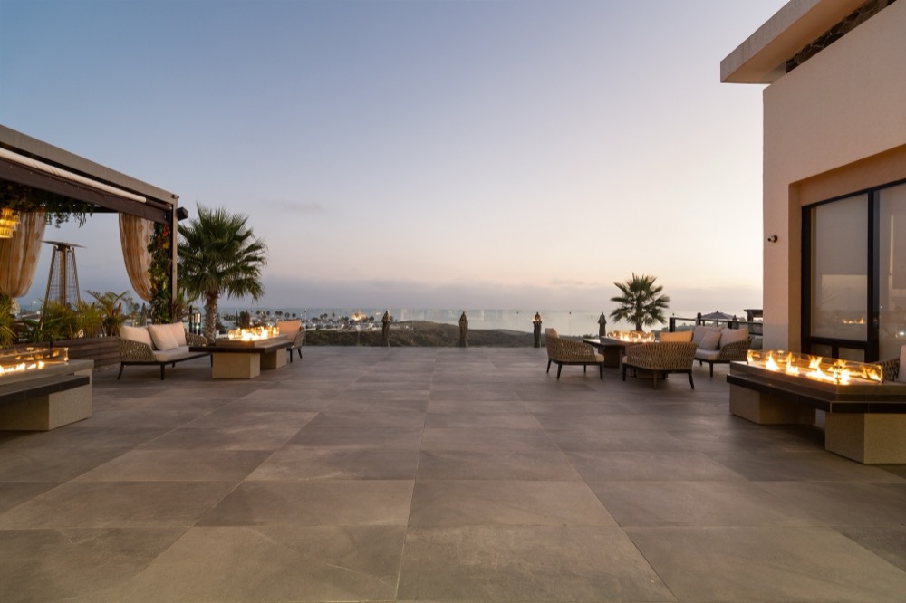 Rooftop fire tables at dusk overlooking the ocean