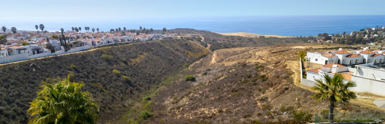 Aerial of the Loma Serena community with the coast behind